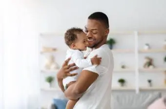 Parent holding child at home