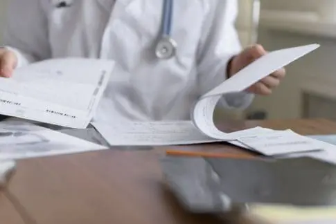 Doctor completing paperwork