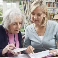 A female caregiver assists a senior