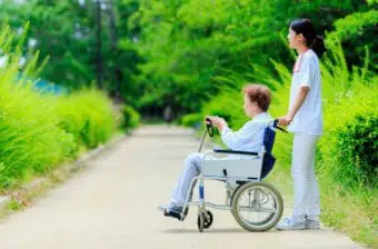 A nurse and a woman in a wheelchair