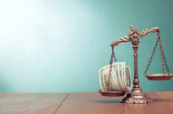 Scale with money representing tax