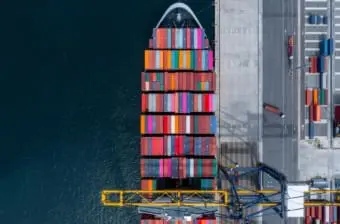 Ship in port loading shipping containers representing trade and tariffs