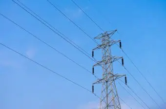 High voltage electricity pylon on blue sky