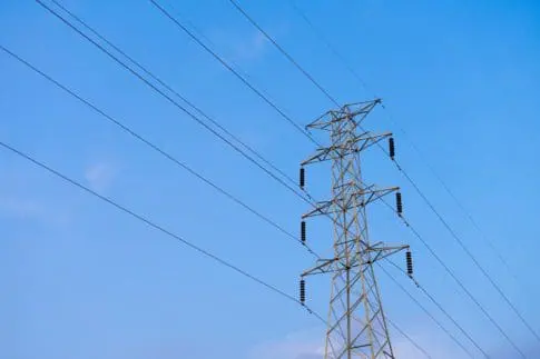 High voltage electricity pylon on blue sky