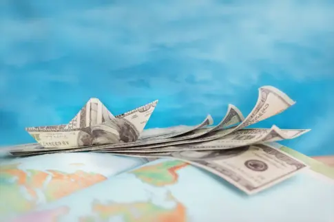 US dollar bills on rest on globe