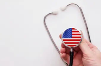 Doctor holding a medical stethoscope with USA flag