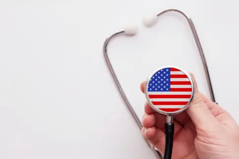 Doctor holding a medical stethoscope with USA flag