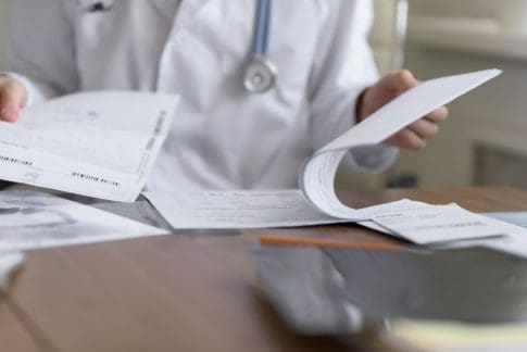 Doctor completing paperwork