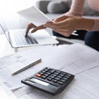 Women with calculator - Household finances after COVID
