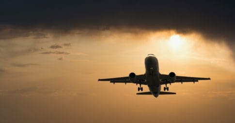 A plane lands amid clouds