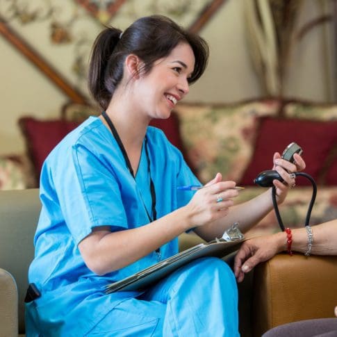 A nurse takes a patient's blood pressure