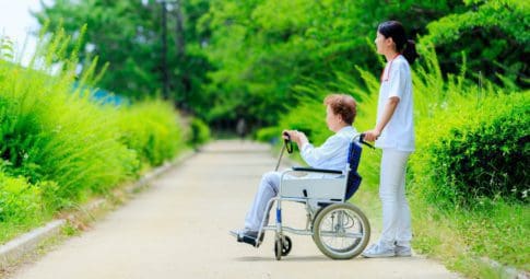 A nurse and a woman in a wheelchair