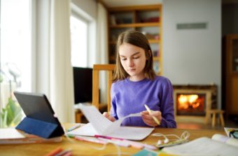 A girl learns at home through homeschooling