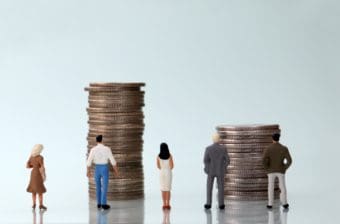 Workers look at money representing wages and inflation